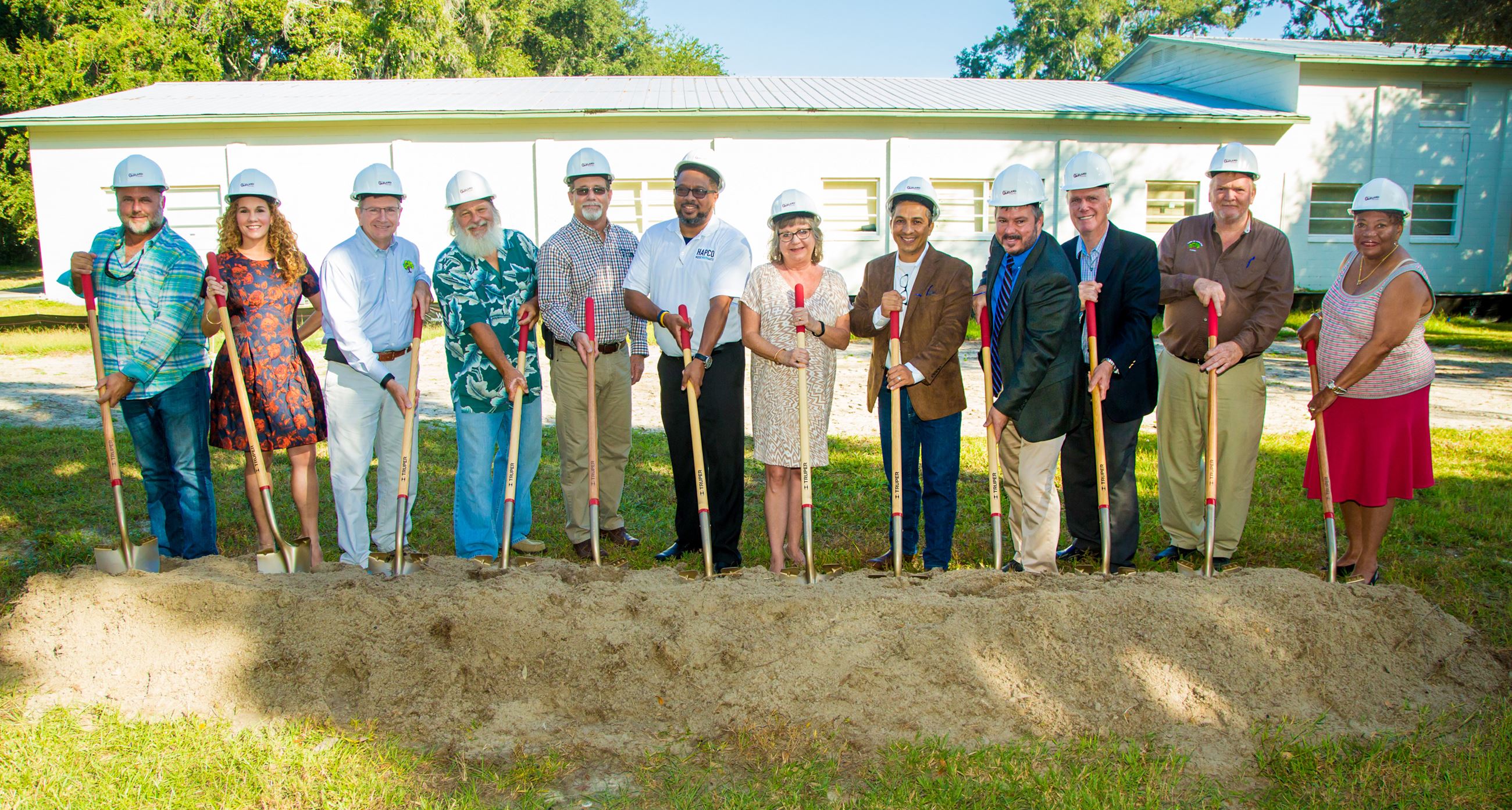 Local official holding shovels for The Arts and Heritage Center groundbreaking ceremony